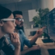 Two people looking at code on a computer